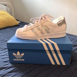 Brand new Adidas iridescent 3-stripes pair with pops of color and pattern.